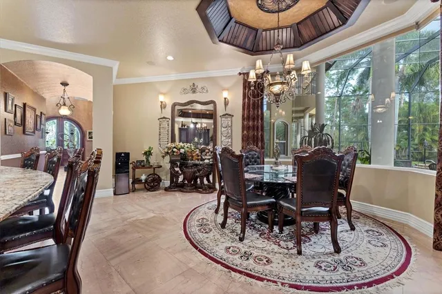 a living room with furniture a dining table and a chandelier