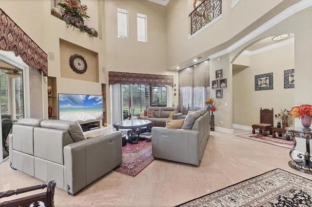 a living room with furniture and a floor to ceiling window