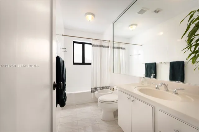 a bathroom with a double vanity sink toilet and shower