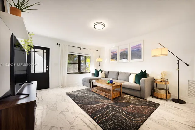 a living room with furniture rug and window