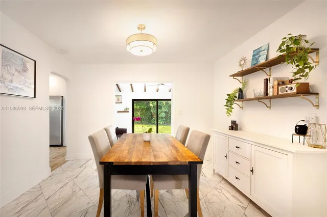 a view of a dining room with furniture and window