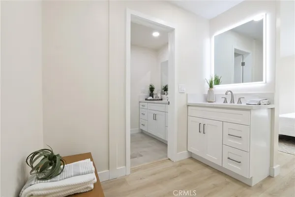 a spacious bathroom with a granite countertop sink and a mirror