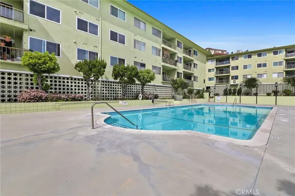 a view of tall building with a swimming pool