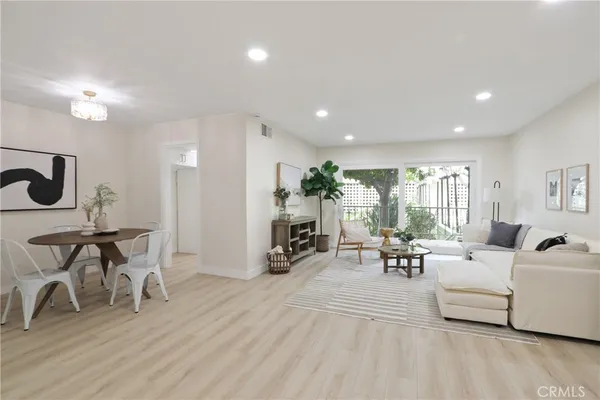 a living room with furniture a wooden floor and a fireplace