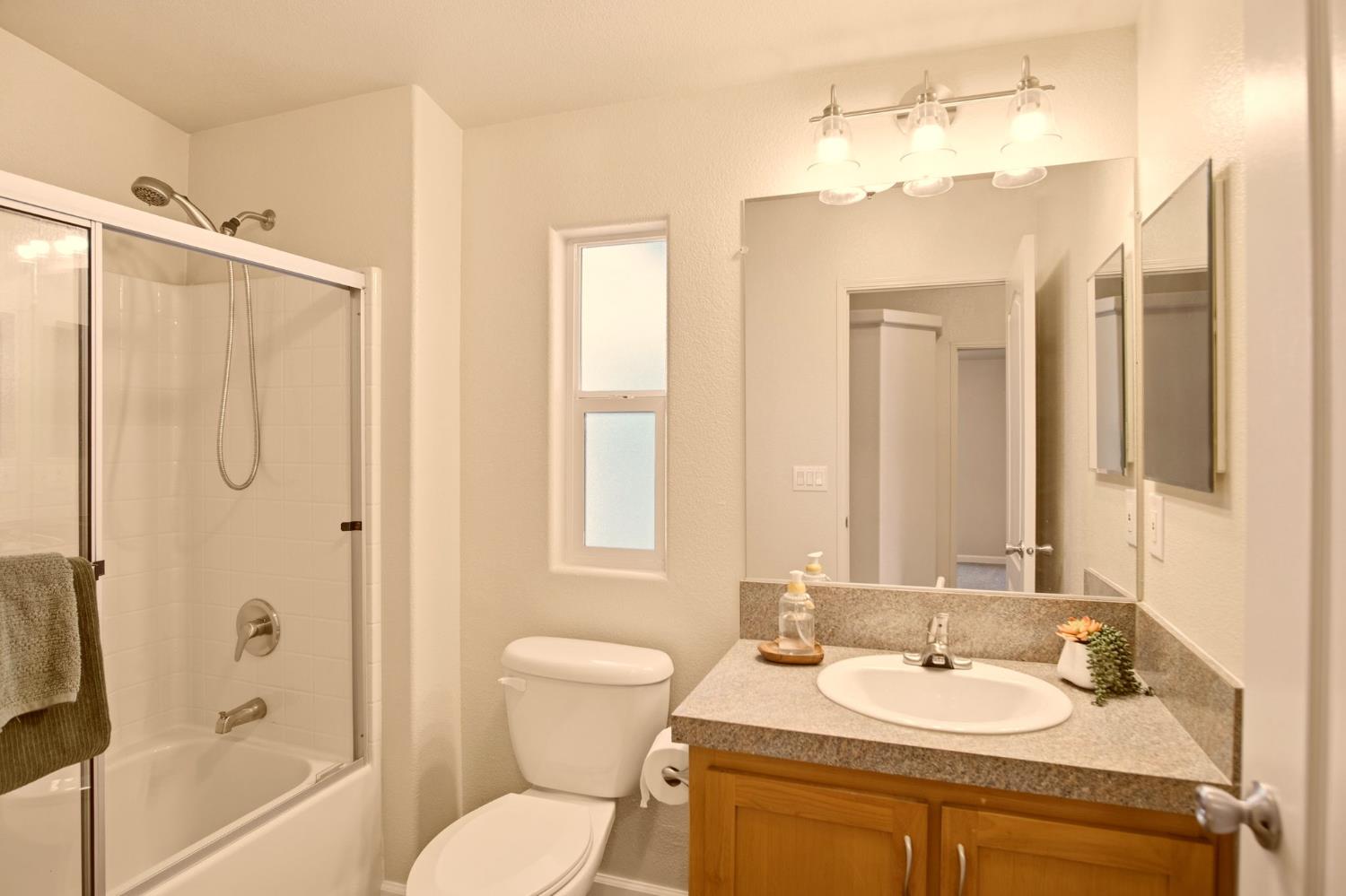145 Dory Lane Modesto, CA 95356 - Photo 16 of 27 a bathroom with a granite countertop sink toilet and shower