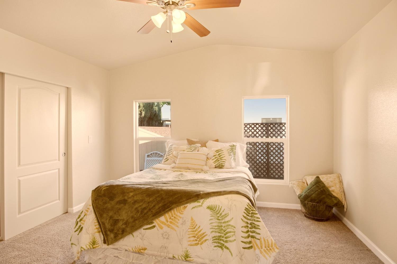 145 Dory Lane Modesto, CA 95356 - Photo 17 of 27 a bedroom with a bed and a chandelier