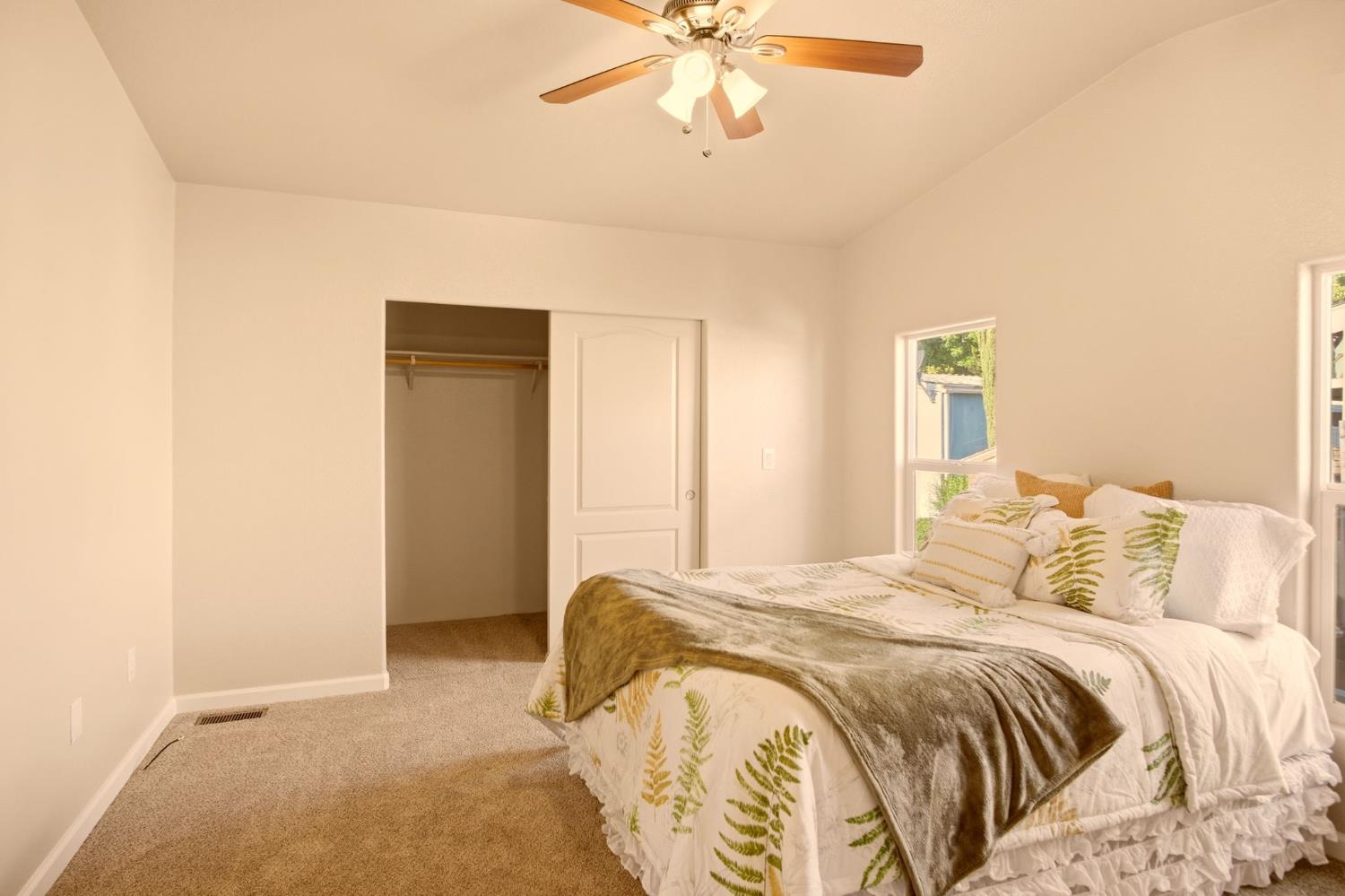 145 Dory Lane Modesto, CA 95356 - Photo 18 of 27 a bedroom with a bed and a chandelier
