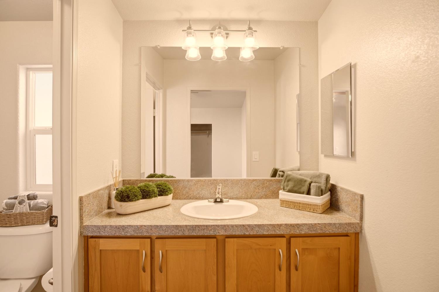 145 Dory Lane Modesto, CA 95356 - Photo 19 of 27 a bathroom with a granite countertop sink and a mirror