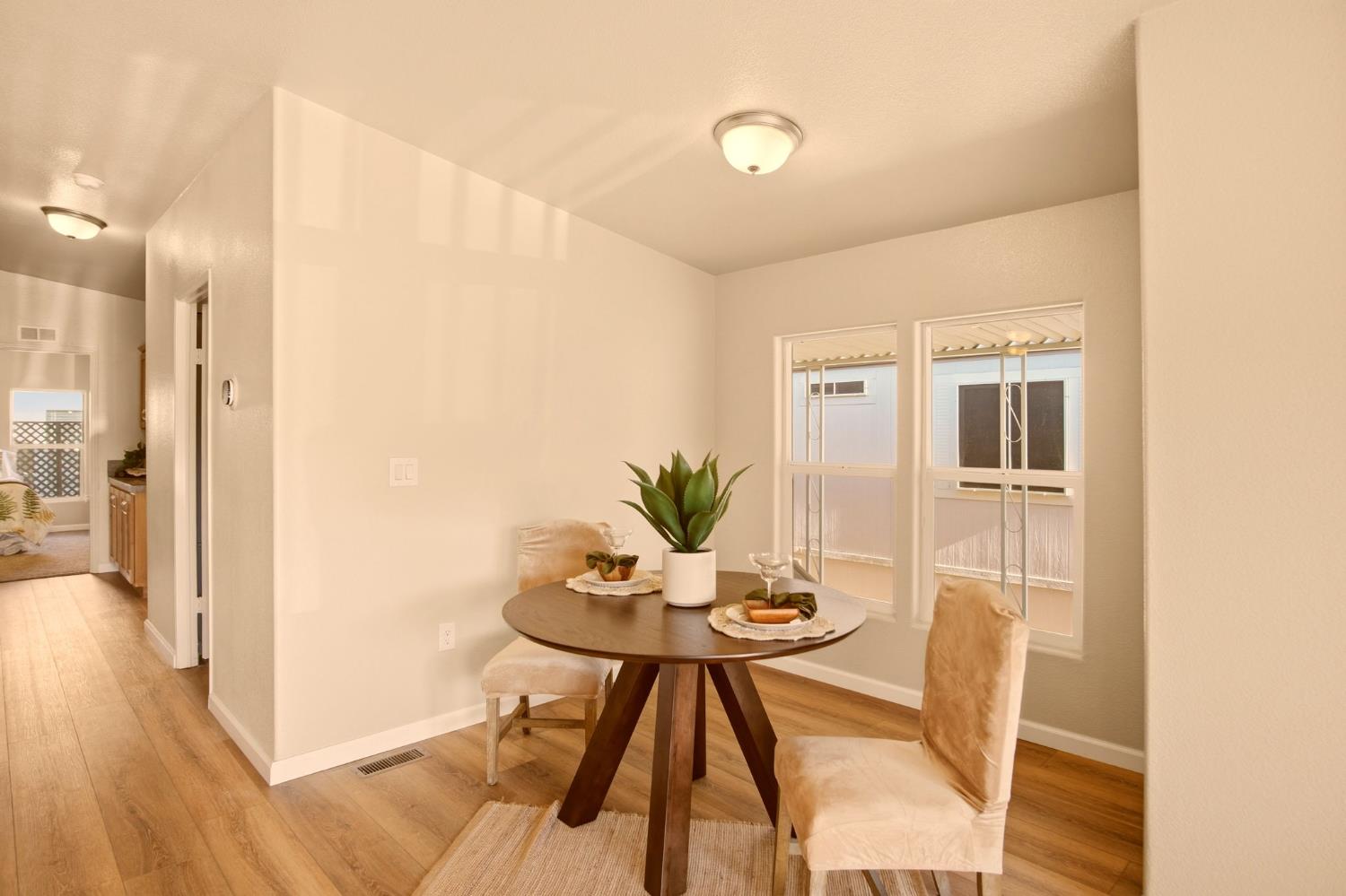 145 Dory Lane Modesto, CA 95356 - Photo 7 of 27 a view of a dining room with furniture and wooden floor