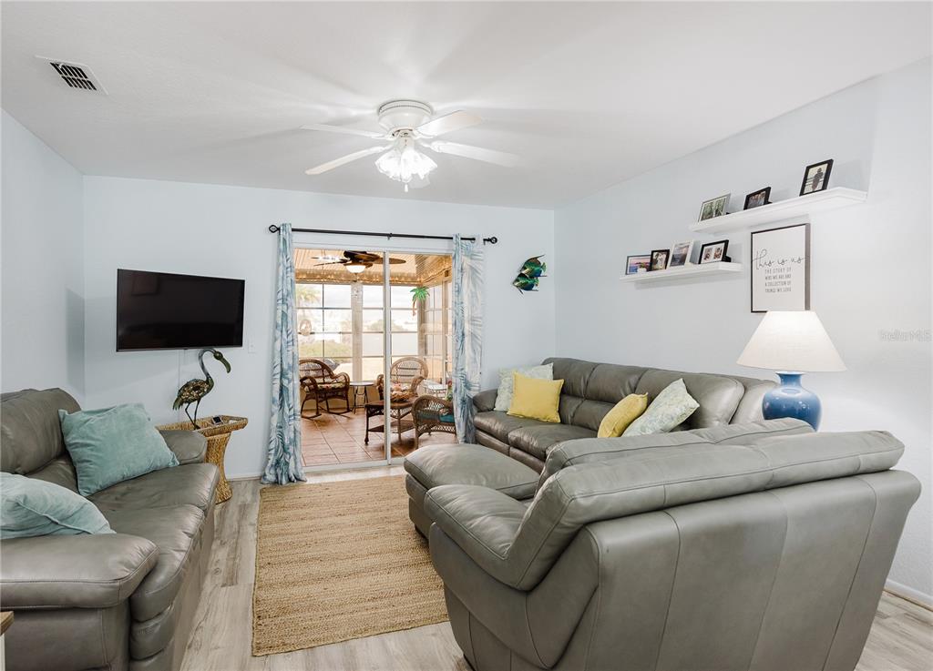 26282 Rampart Boulevard, Unit 204 Punta Gorda, FL 33983 - Photo 13 of 34 a living room with furniture and a flat screen tv