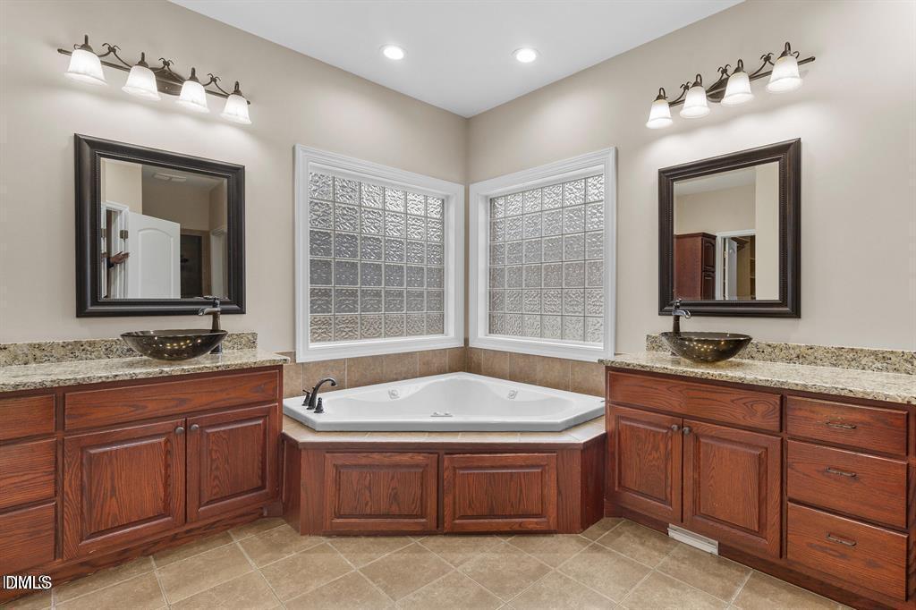 2751 Buie - Philadelphus Road Pembroke, NC 28372 - Photo 11 of 30 a spacious bathroom with a tub sink and mirror