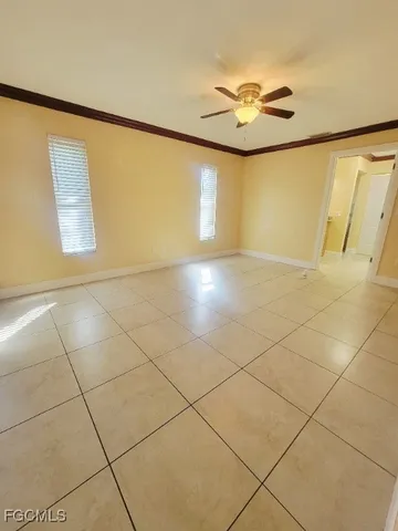 a view of a livingroom with kitchen and an window