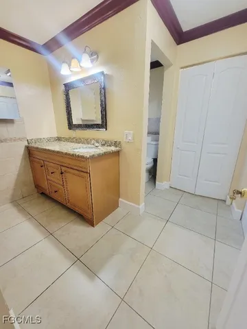a spacious bathroom with a granite countertop sink and a mirror