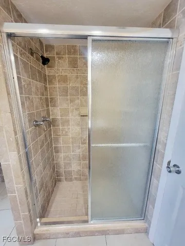 a bathroom with a glass door shower