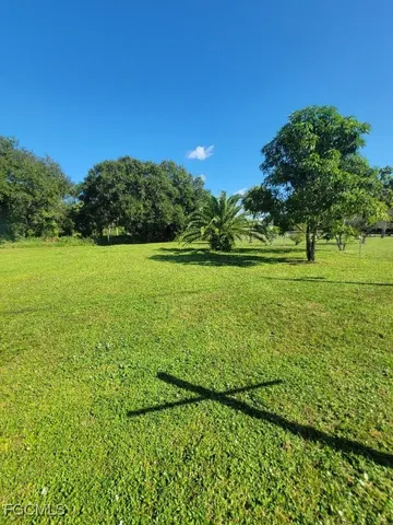 a view of a big yard with an outdoor space and seating