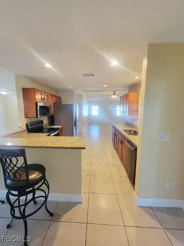 a kitchen with stainless steel appliances a refrigerator and a stove top oven
