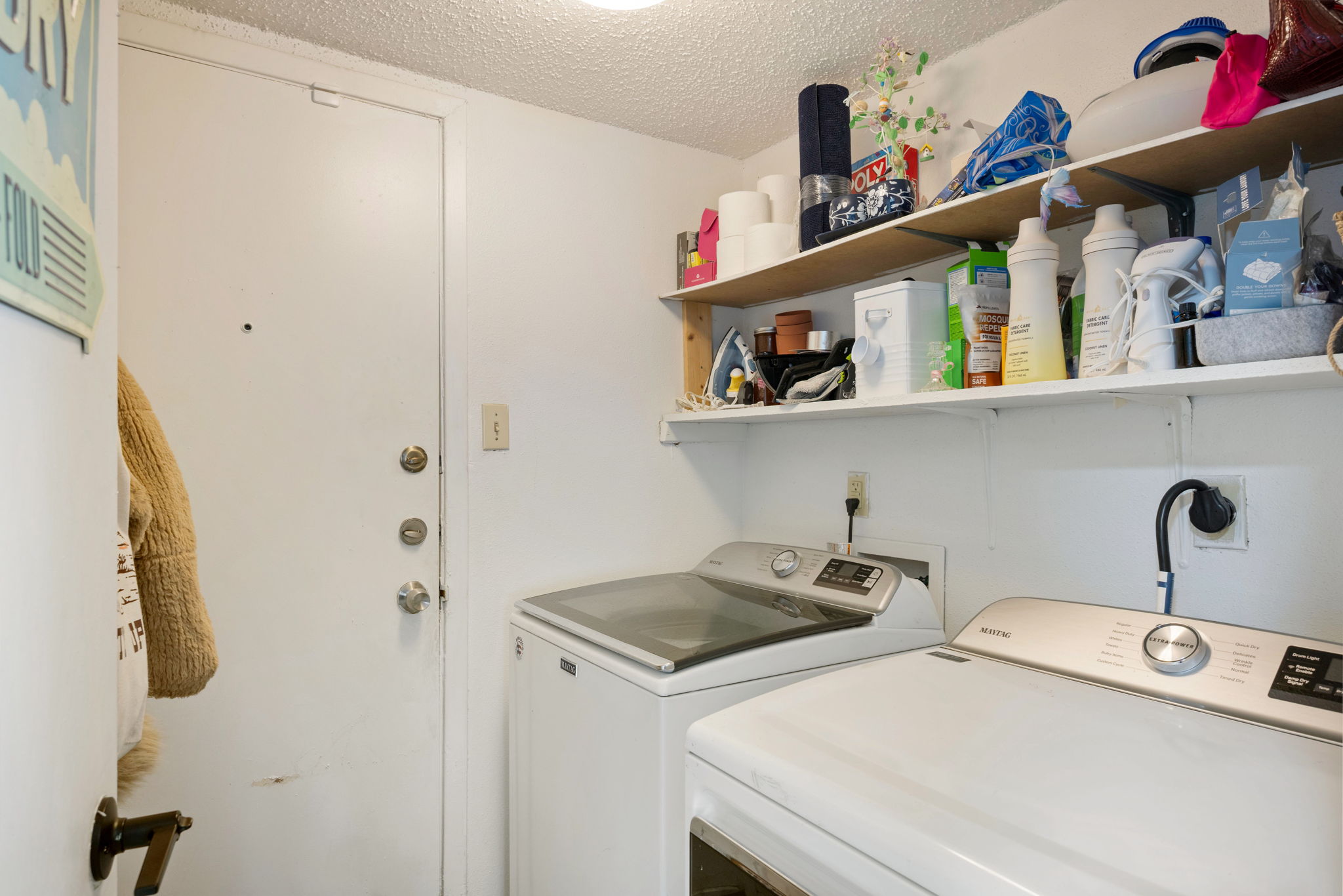8317 Forest Ridge Drive San Antonio, TX 78239 - Photo 9 of 26 Well-equipped laundry area with ample shelving and modern appliances for efficient chores.