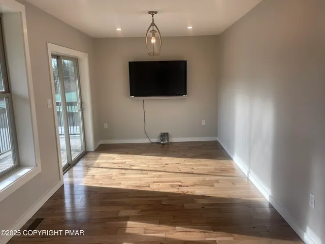 a kitchen with stainless steel appliances granite countertop a stove top oven a sink and a microwave