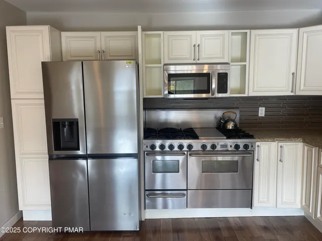 a view of livingroom with hardwood floor and a ceiling fan