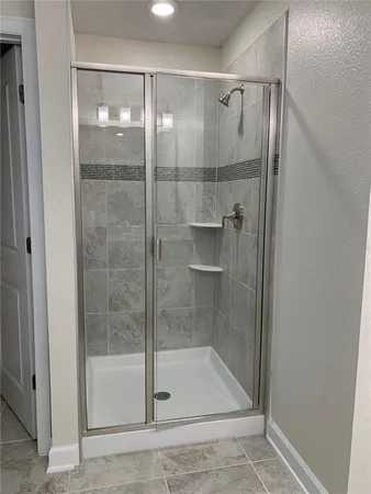 a bathroom with a glass shower door