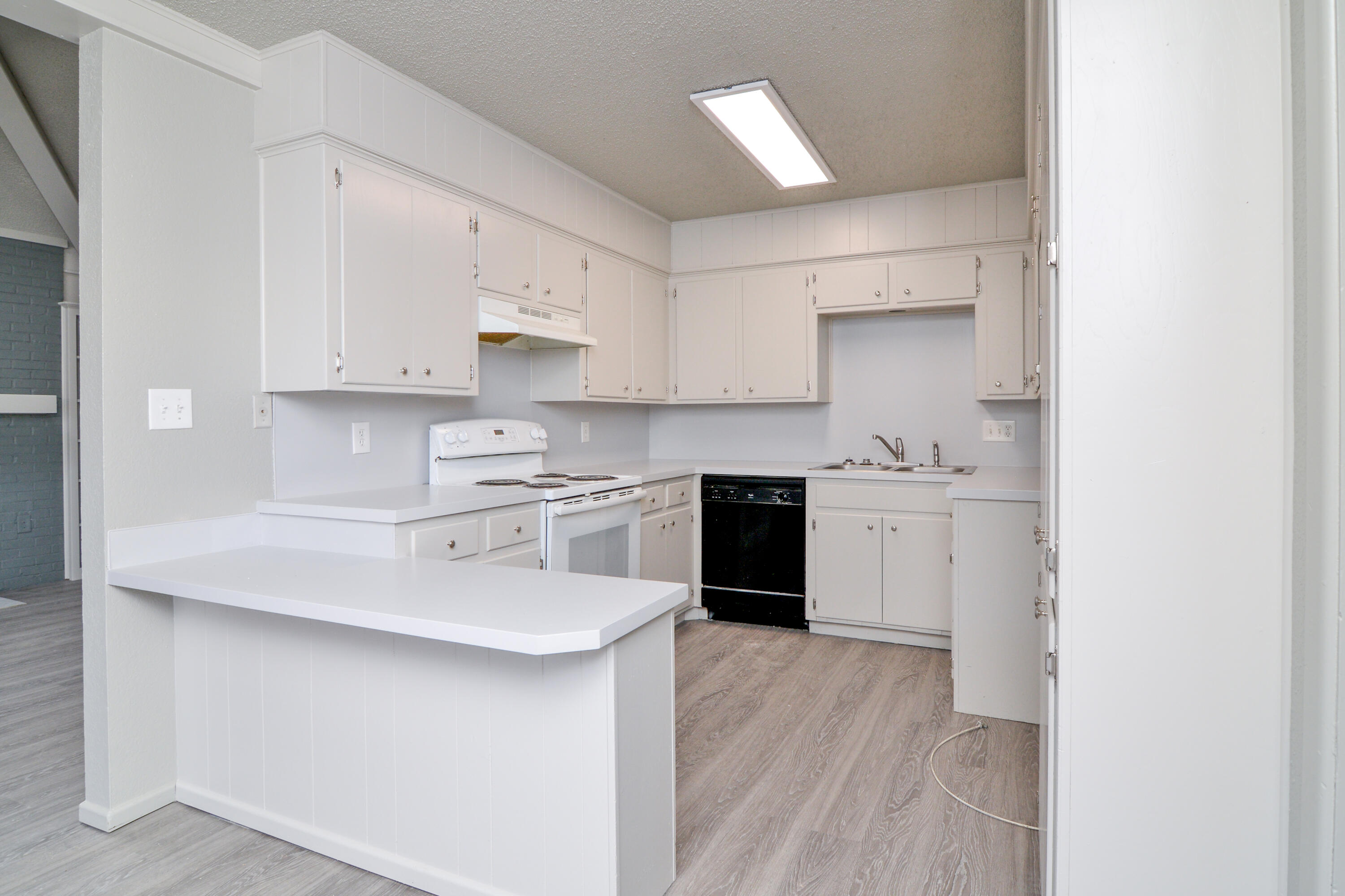3714 53rd Street, Unit A & B Lubbock, TX 79413 - Photo 12 of 28 a kitchen with stainless steel appliances granite countertop a sink stove and refrigerator