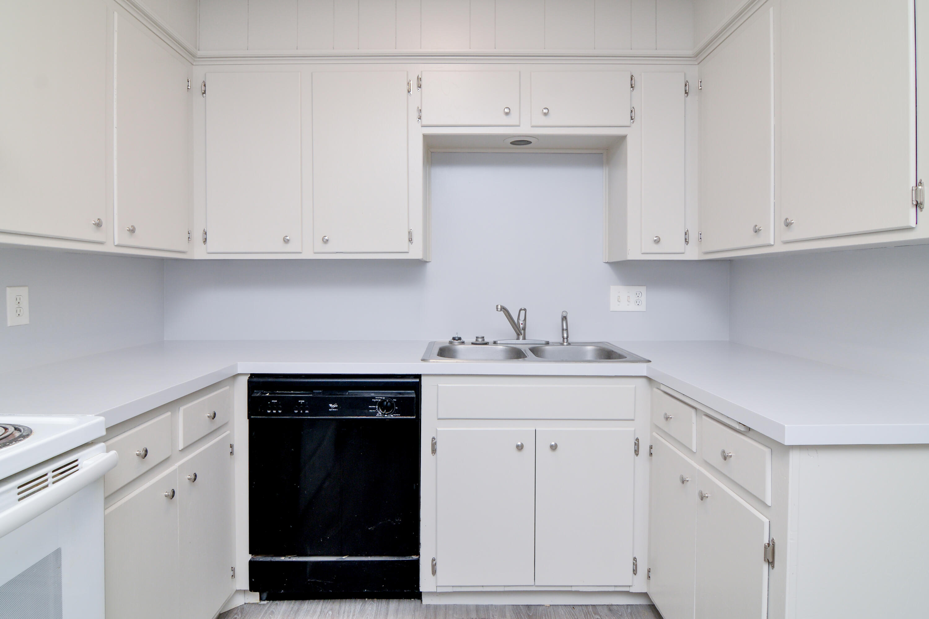 3714 53rd Street, Unit A & B Lubbock, TX 79413 - Photo 13 of 28 a kitchen with white cabinets and a sink