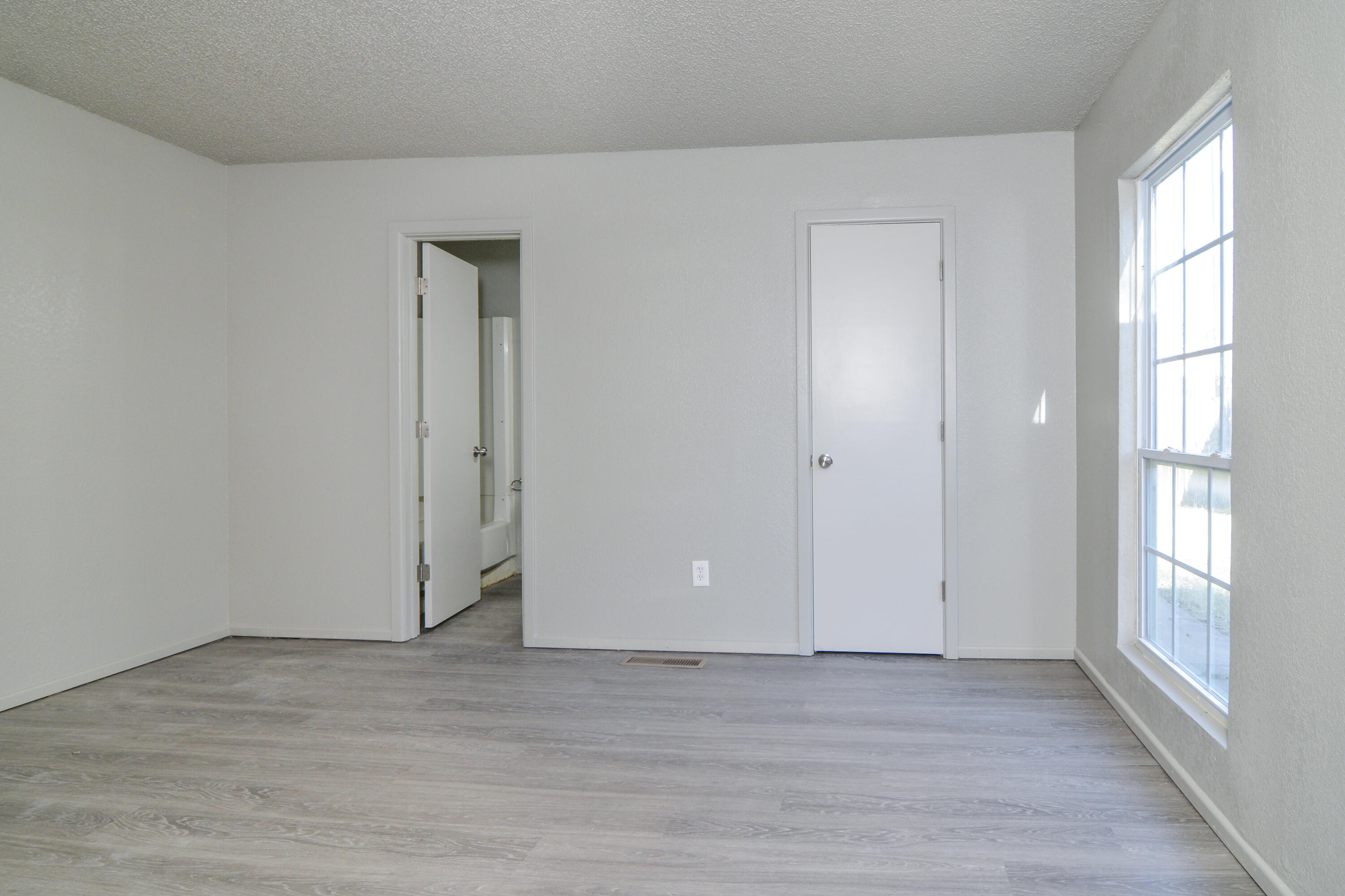 3714 53rd Street, Unit A & B Lubbock, TX 79413 - Photo 18 of 28 a view of an empty room with wooden floor and a window