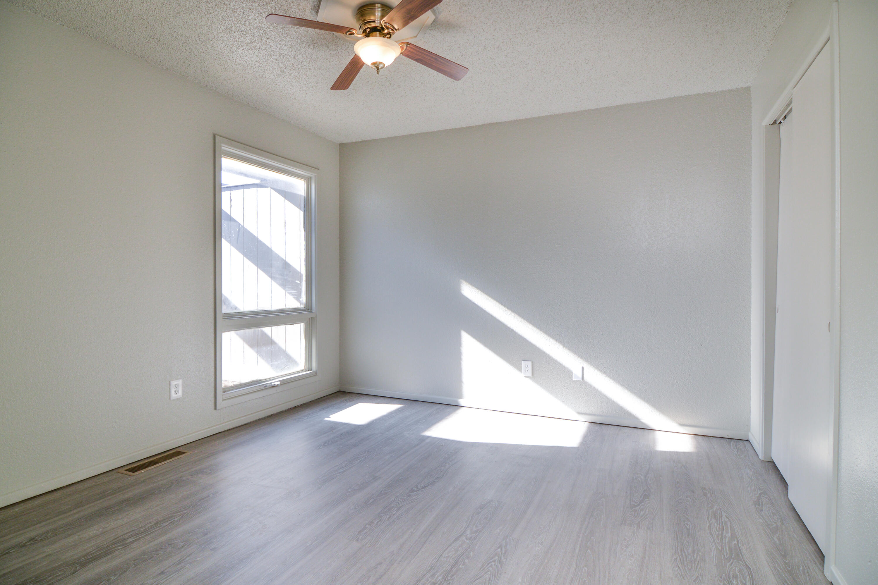 3714 53rd Street, Unit A & B Lubbock, TX 79413 - Photo 20 of 28 an empty room with wooden floor fan and windows