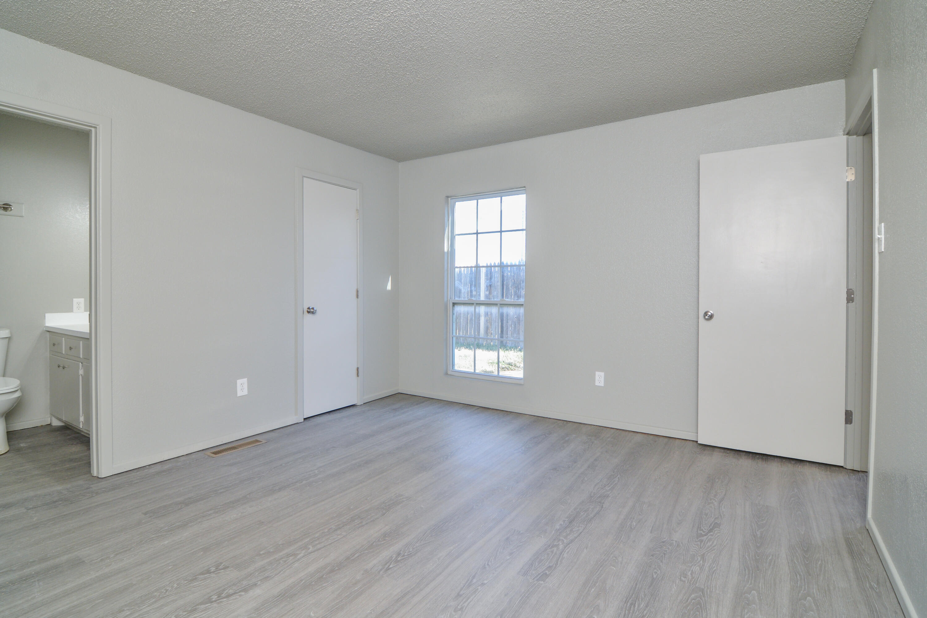 3714 53rd Street, Unit A & B Lubbock, TX 79413 - Photo 21 of 28 a view of an empty room with wooden floor and a window