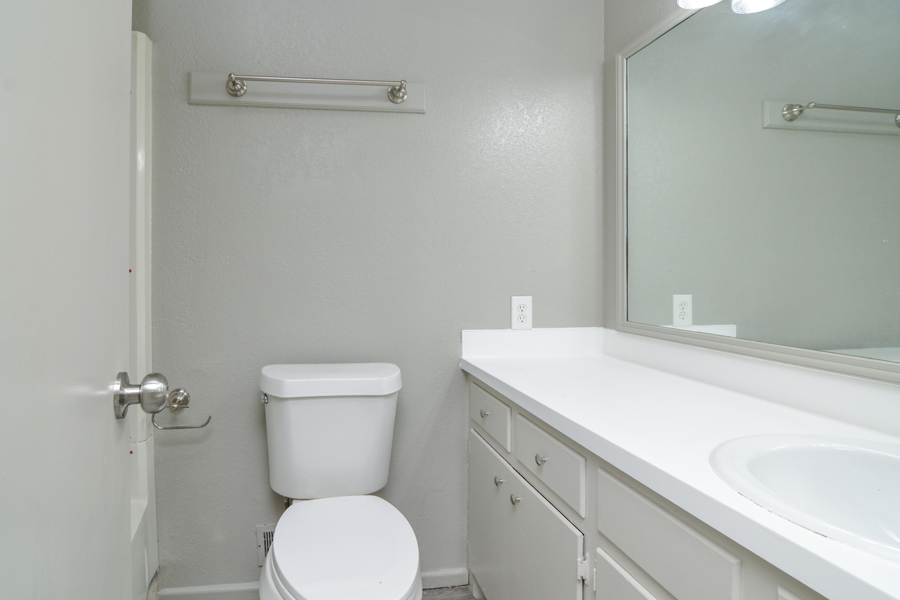 3714 53rd Street, Unit A & B Lubbock, TX 79413 - Photo 23 of 28 a bathroom with a toilet sink and mirror