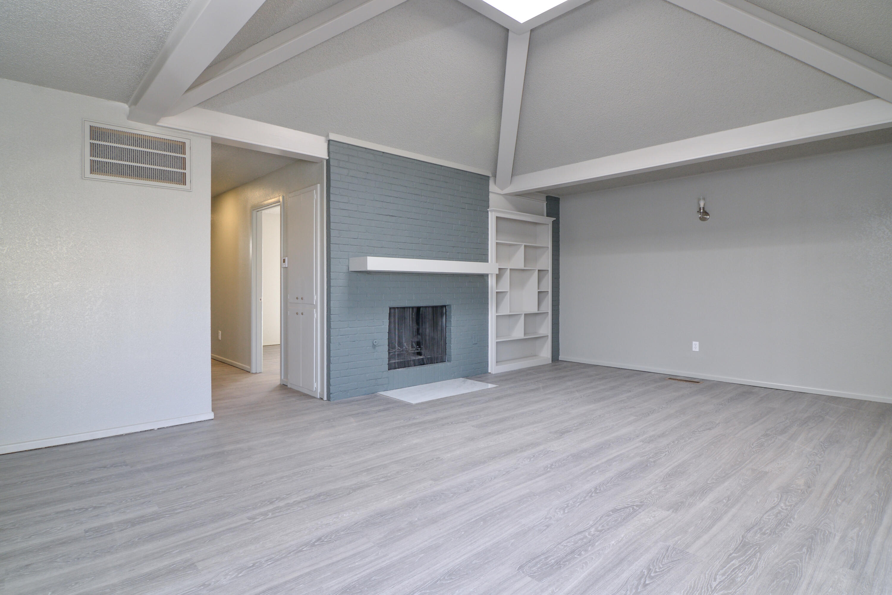 3714 53rd Street, Unit A & B Lubbock, TX 79413 - Photo 4 of 28 an empty room with wooden floor fireplace and windows