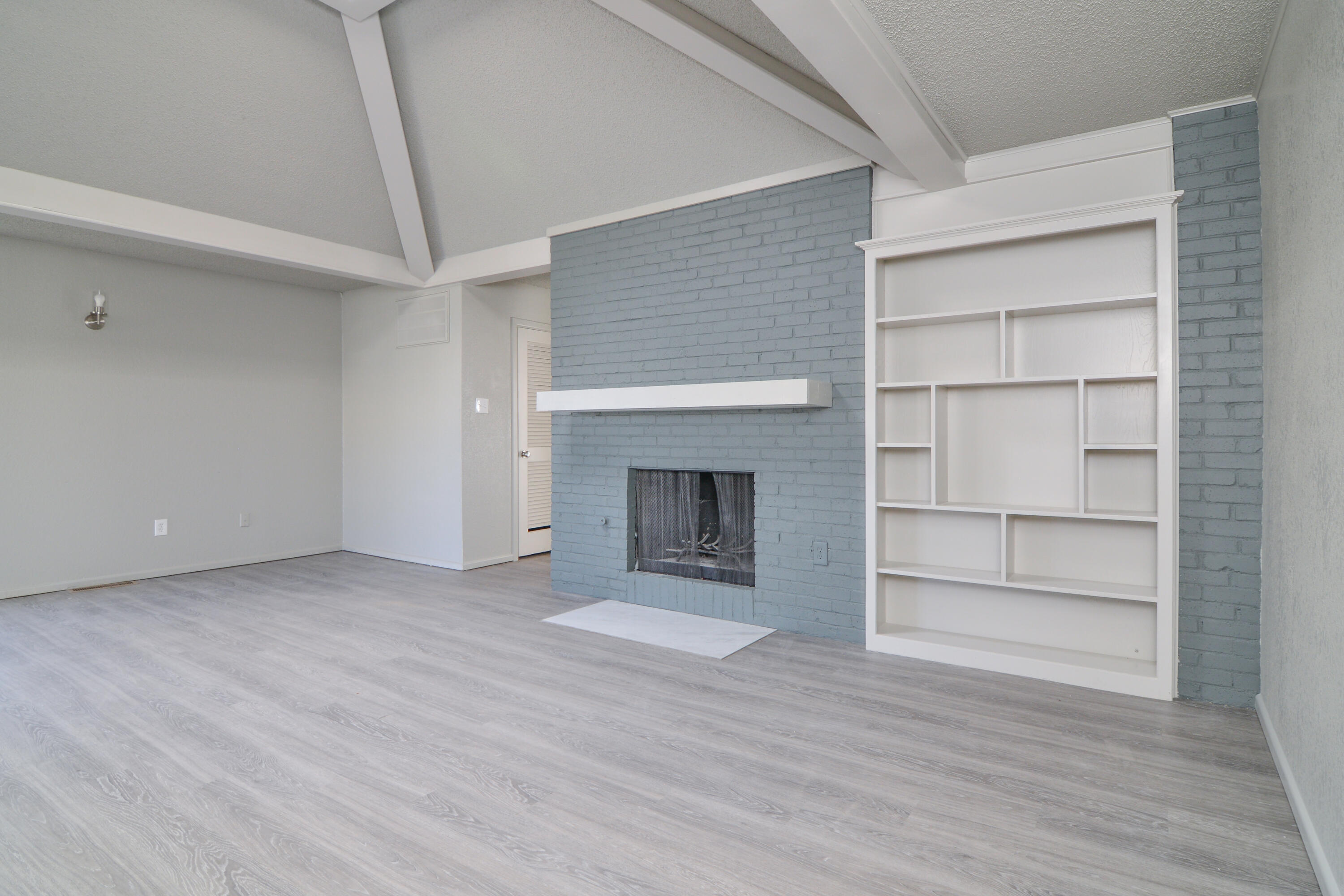 3714 53rd Street, Unit A & B Lubbock, TX 79413 - Photo 6 of 28 a view of an empty room with a fireplace and cabinet