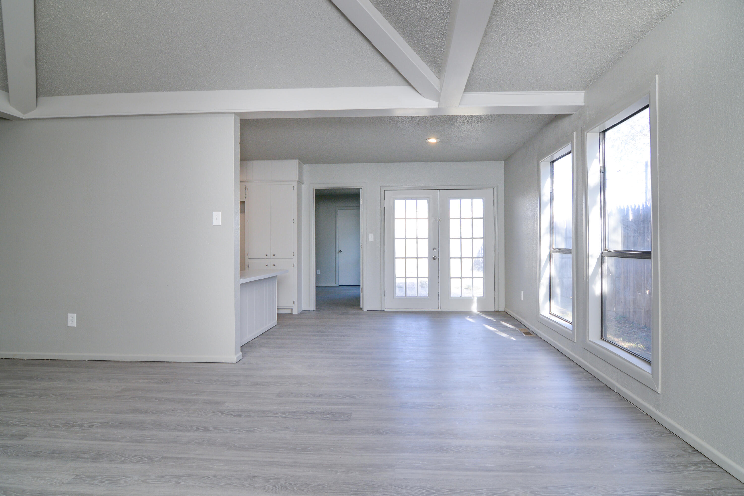 3714 53rd Street, Unit A & B Lubbock, TX 79413 - Photo 9 of 28 a view of an empty room with wooden floor and a window