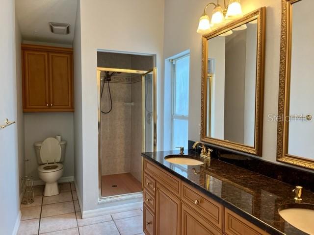 405 Arlington Avenue East Oldsmar, FL 34677 - Photo 13 of 21 a bathroom with a granite countertop sink toilet and shower