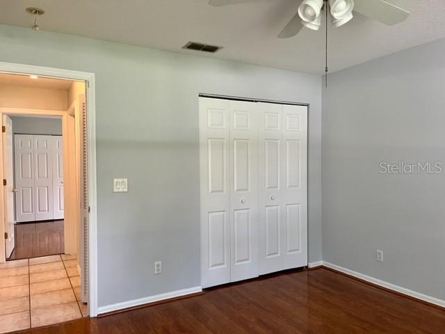 405 Arlington Avenue East Oldsmar, FL 34677 - Photo 15 of 21 a view of an empty room with wooden floor and a chandelier