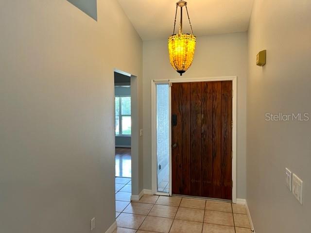 405 Arlington Avenue East Oldsmar, FL 34677 - Photo 17 of 21 an empty room with wooden floor and mirror