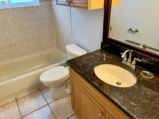 405 Arlington Avenue East Oldsmar, FL 34677 - Photo 19 of 21 a bathroom with a granite countertop sink toilet and a mirror