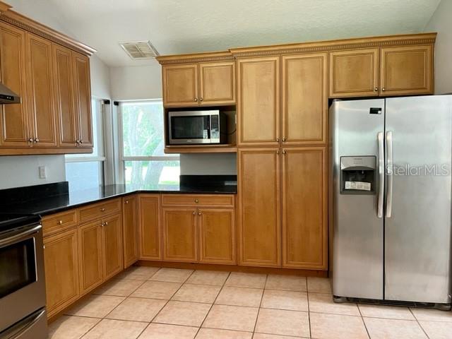 405 Arlington Avenue East Oldsmar, FL 34677 - Photo 9 of 21 a kitchen with stainless steel appliances granite countertop a refrigerator and a stove top oven