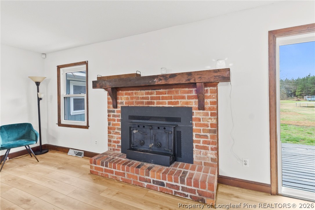 730 Slocomb Road Fayetteville, NC 28311 - Photo 11 of 48 a living room with furniture and a fireplace