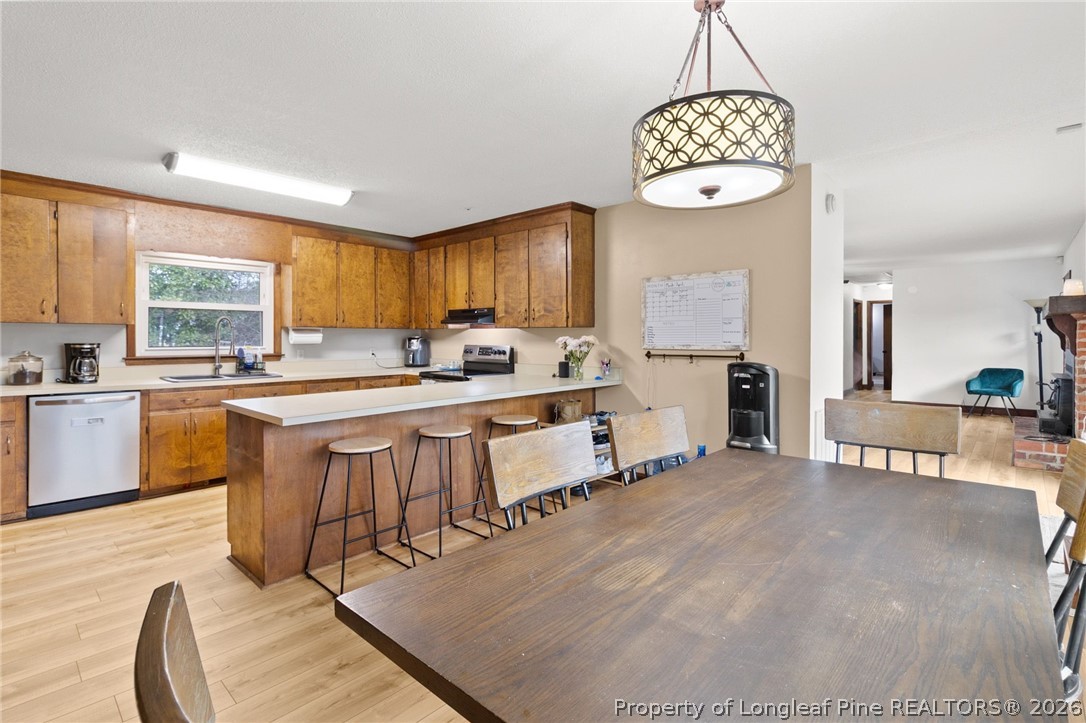 730 Slocomb Road Fayetteville, NC 28311 - Photo 14 of 48 a large kitchen with kitchen island granite countertop a stove a sink a dining table and chairs