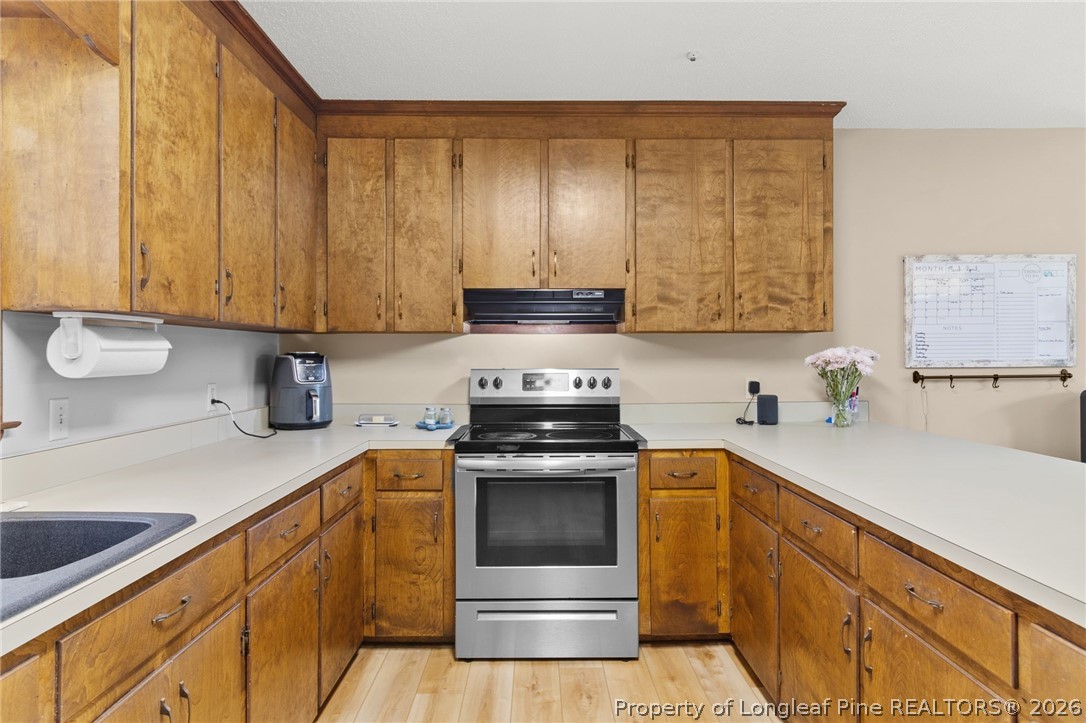 730 Slocomb Road Fayetteville, NC 28311 - Photo 15 of 48 a kitchen with a sink stove and cabinets