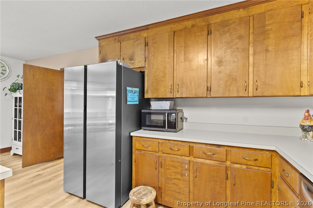 730 Slocomb Road Fayetteville, NC 28311 - Photo 17 of 48 a kitchen with stainless steel appliances granite countertop a refrigerator and a sink