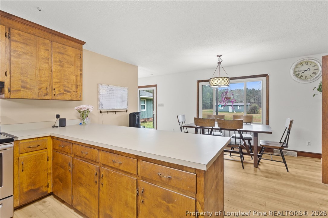 730 Slocomb Road Fayetteville, NC 28311 - Photo 18 of 48 a open kitchen with stainless steel appliances granite countertop a table chairs sink and cabinets