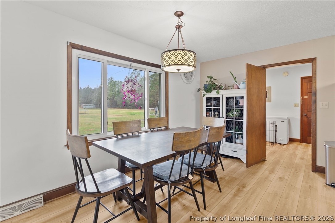 730 Slocomb Road Fayetteville, NC 28311 - Photo 19 of 48 a view of a dining room with furniture window and wooden floor