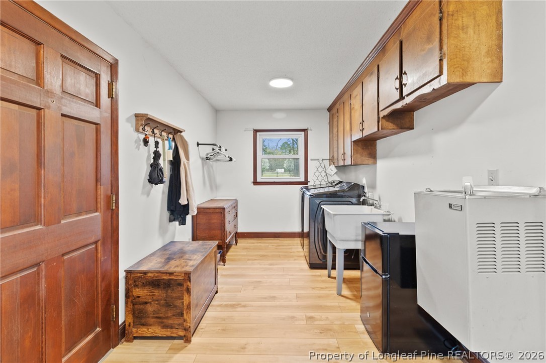 730 Slocomb Road Fayetteville, NC 28311 - Photo 20 of 48 a living room with stainless steel appliances furniture a fireplace and a kitchen view