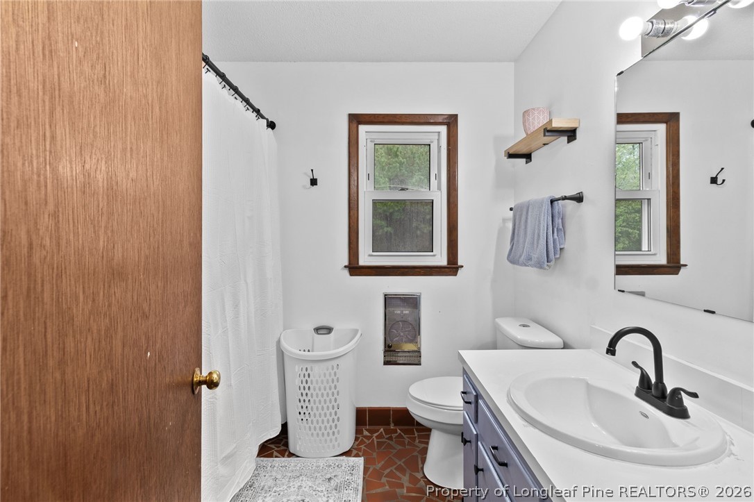 730 Slocomb Road Fayetteville, NC 28311 - Photo 24 of 48 a bathroom with a sink a toilet and mirror