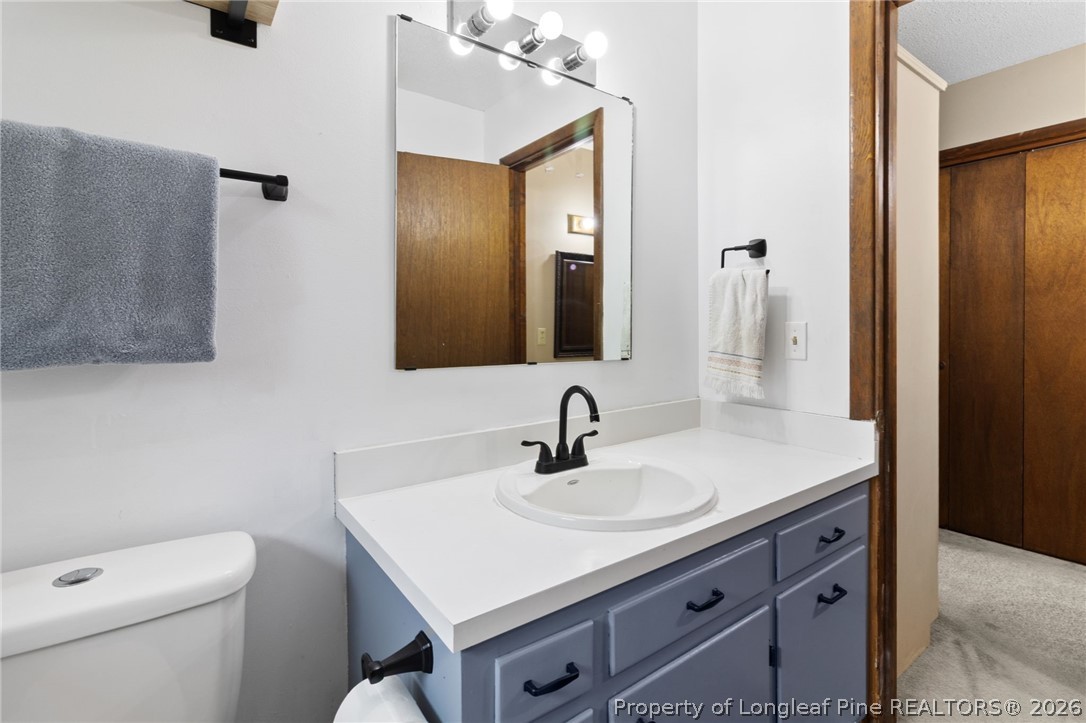 730 Slocomb Road Fayetteville, NC 28311 - Photo 25 of 48 a bathroom with a sink toilet and mirror