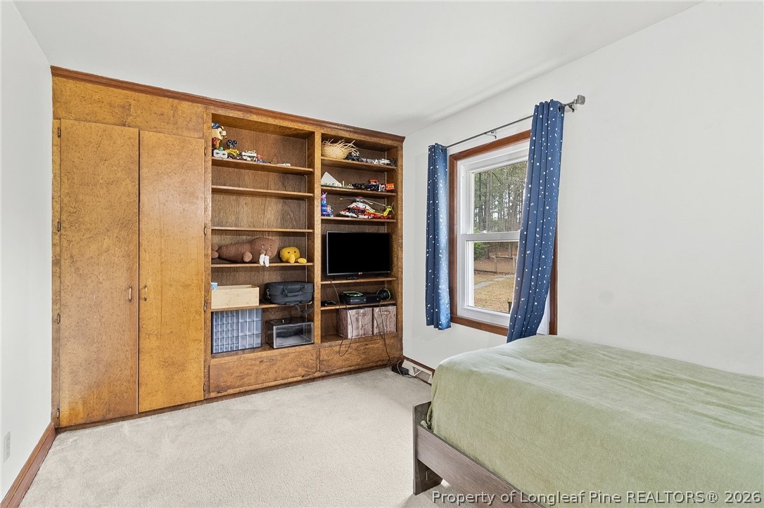 730 Slocomb Road Fayetteville, NC 28311 - Photo 26 of 48 a bedroom with a bed and a walk in closet