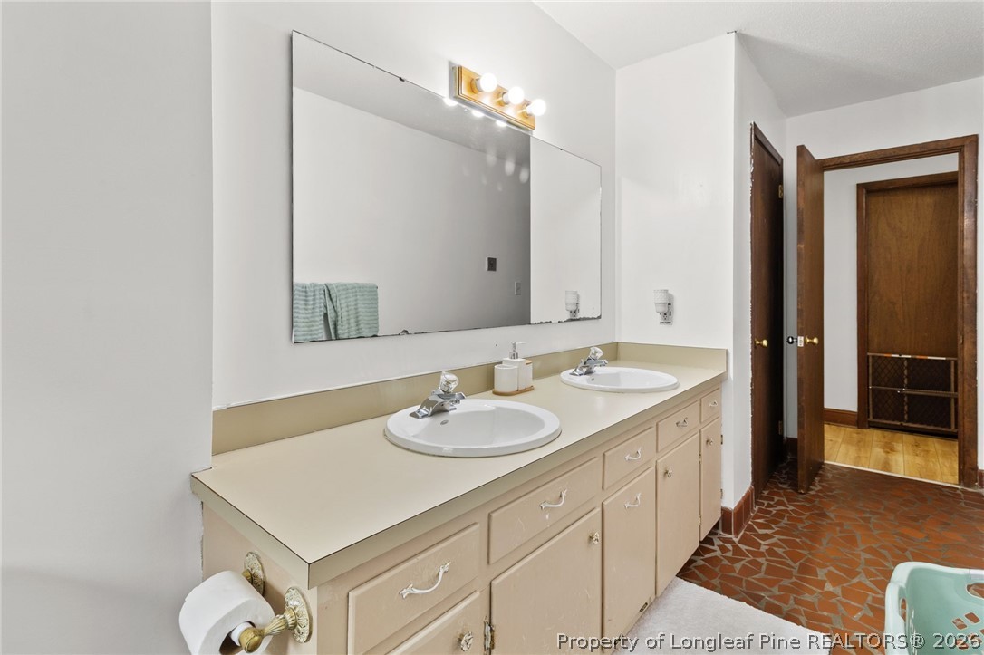 730 Slocomb Road Fayetteville, NC 28311 - Photo 29 of 48 a bathroom with a sink and a mirror