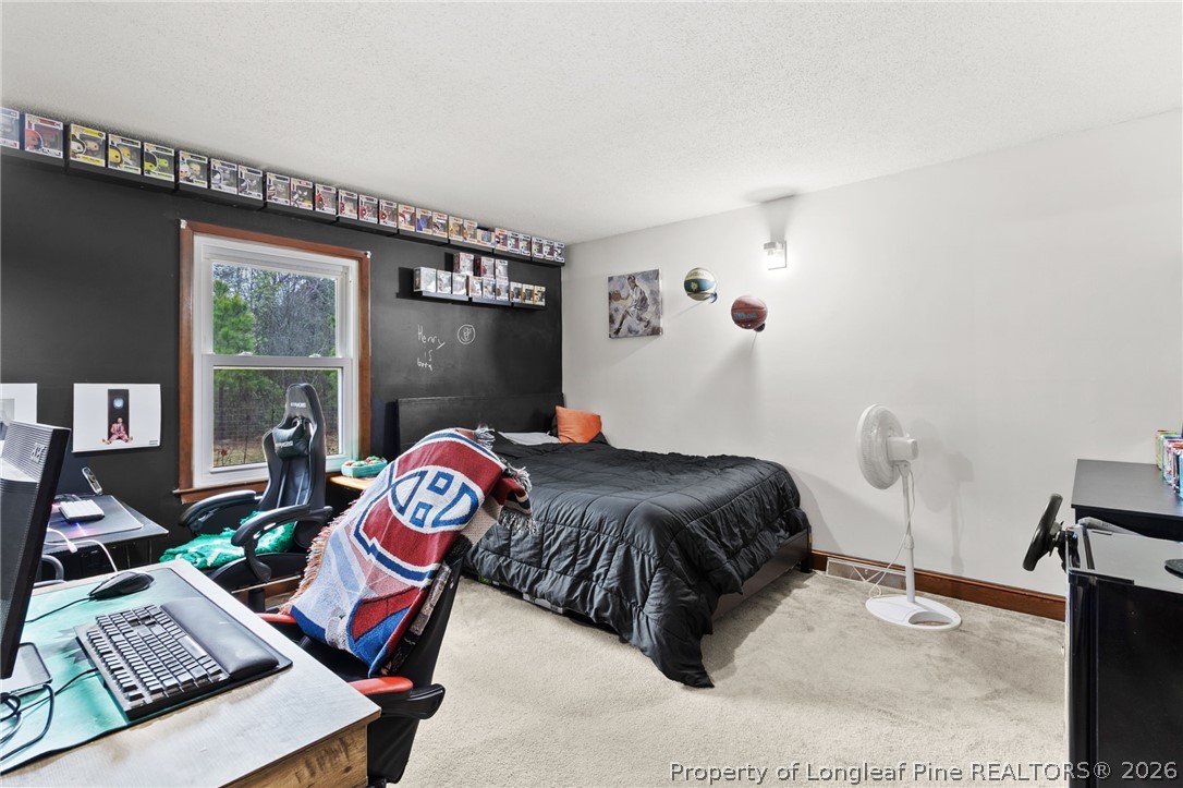 730 Slocomb Road Fayetteville, NC 28311 - Photo 30 of 48 a bedroom with a bed and a window